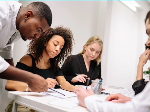 A group of work colleagues working together in an office.